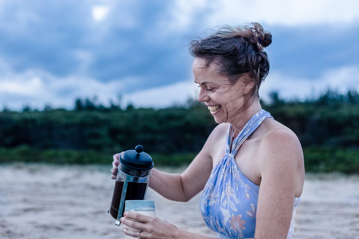 Mummas Beans founder Maika pouring coffee at the beach