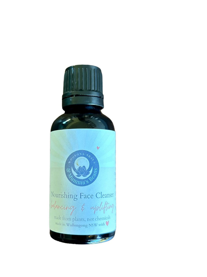 A glass bottle containing nourishing oil-based face cleanser with a label that includes the product name and a brief description.
