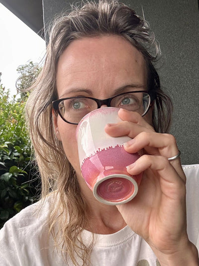 drinking from a ceramic mug