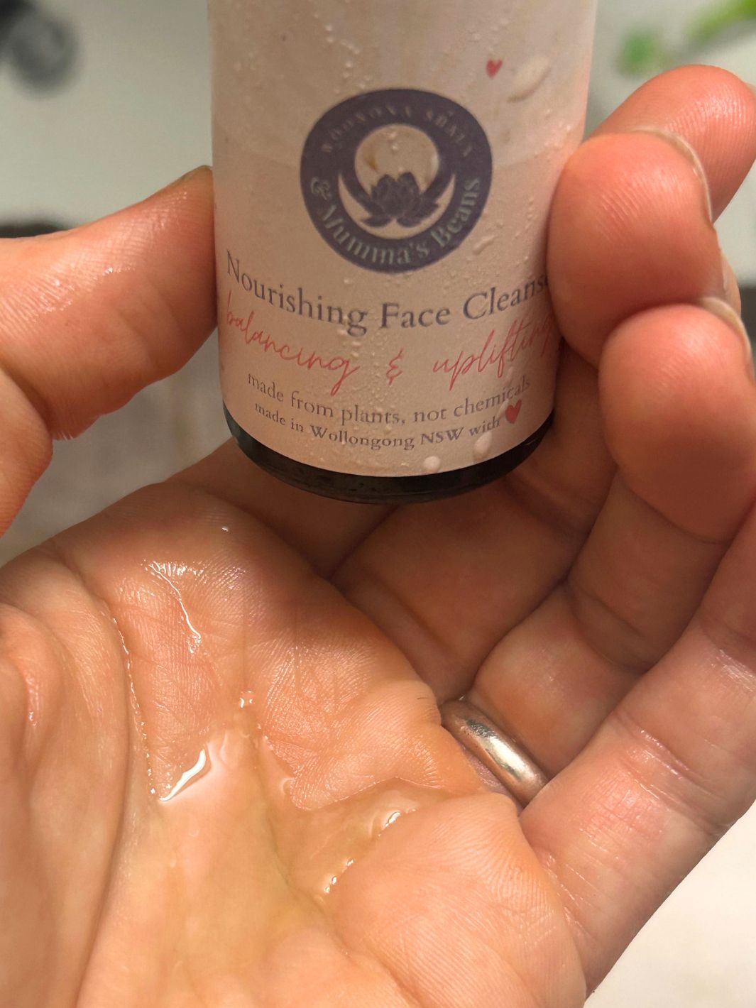 nourishing gentle face cleanser in hand