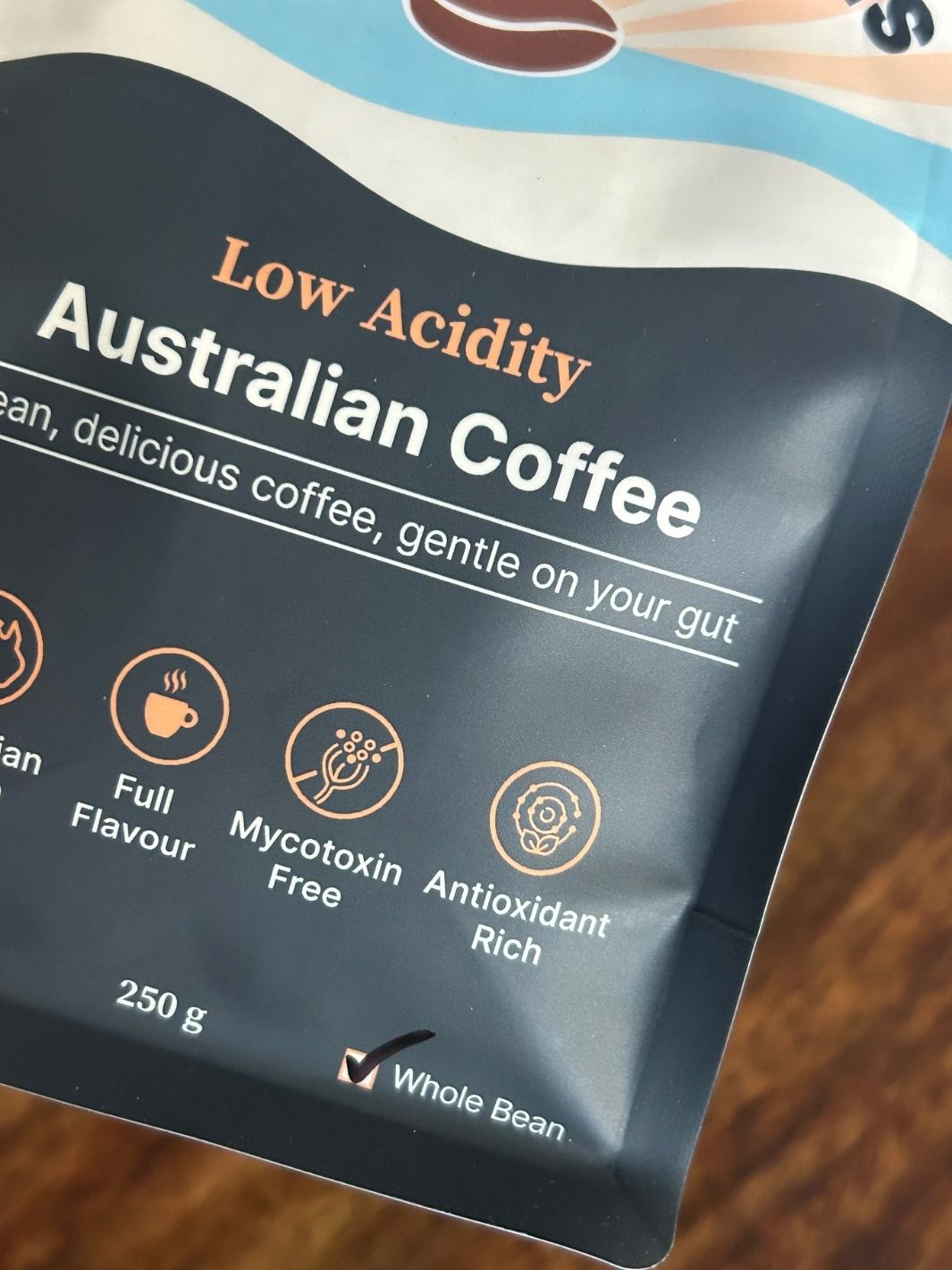 Low Acidity Australian Coffee package on a wooden surface