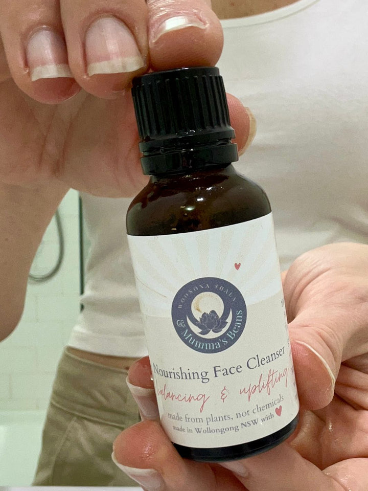 Bottle of Nourishing Hydrating Face Cleanser held by a person